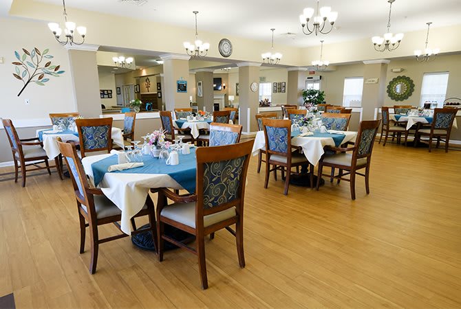 An elegant dining room with neatly arranged tables and chairs.