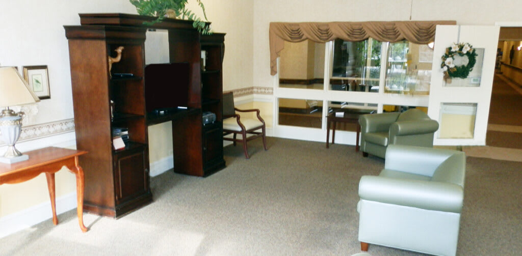 A cozy living room with comfortable seating and a wooden entertainment center.