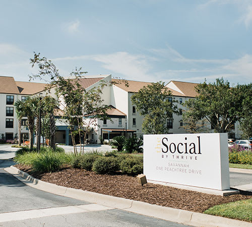 A view of a residential complex with a prominent entrance sign reading 'Social'.