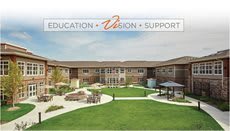 A modern educational facility surrounded by landscaped grounds.