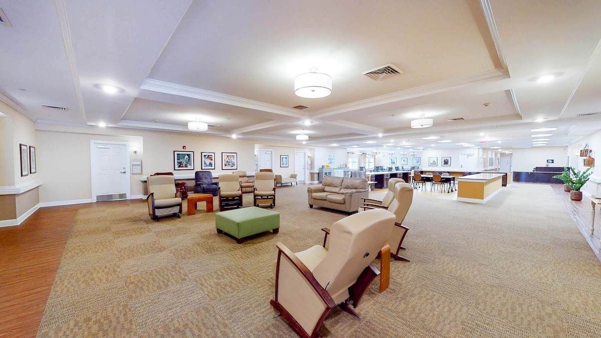 A spacious lounge area with comfortable seating and modern lighting.