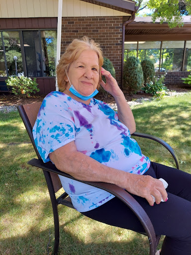 Enjoying a sunny day outside, this cheerful woman radiates positivity.