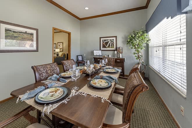 A beautifully arranged dining room with a set table and elegant decor.