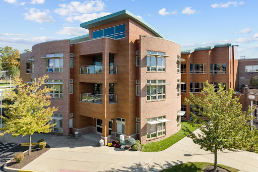 A modern residential building featuring a brick facade and ample natural light.