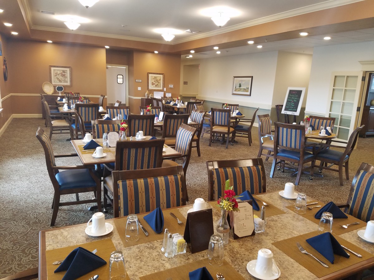 A neatly arranged dining room with tables set for service.