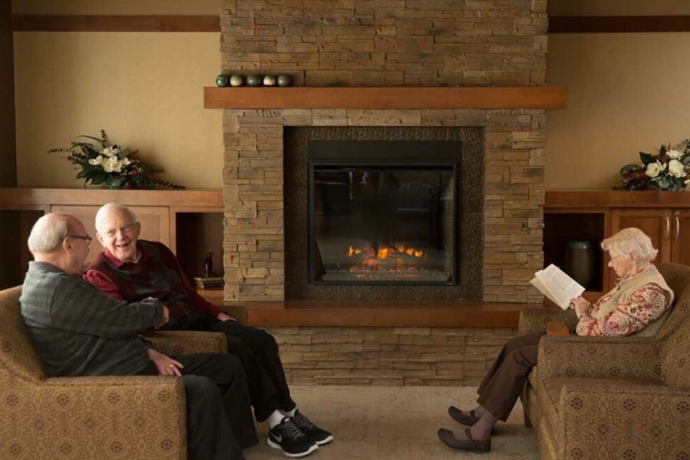 People relaxing by a fireplace in a cozy living room.