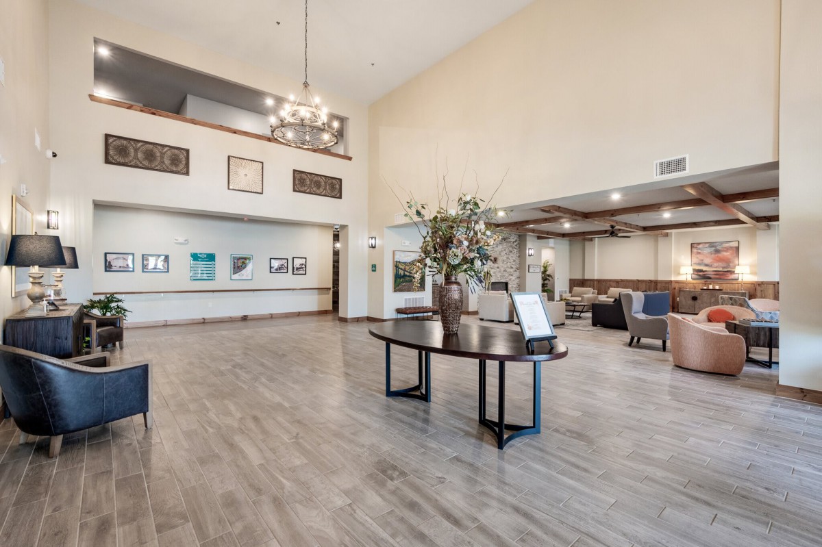 A spacious and elegantly designed lobby with modern decor and a central reception table.