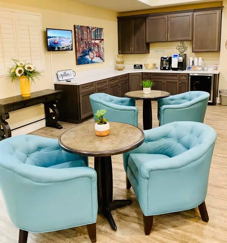 A cozy lounge area with modern furnishings and a coffee station.