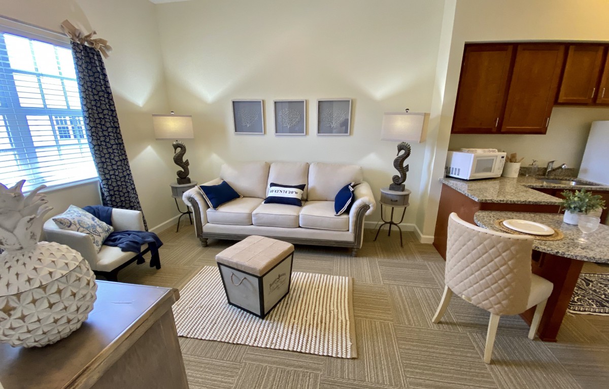 A modern living room with a cozy atmosphere, featuring a comfortable sofa, stylish lamps, and neutral-colored decor.