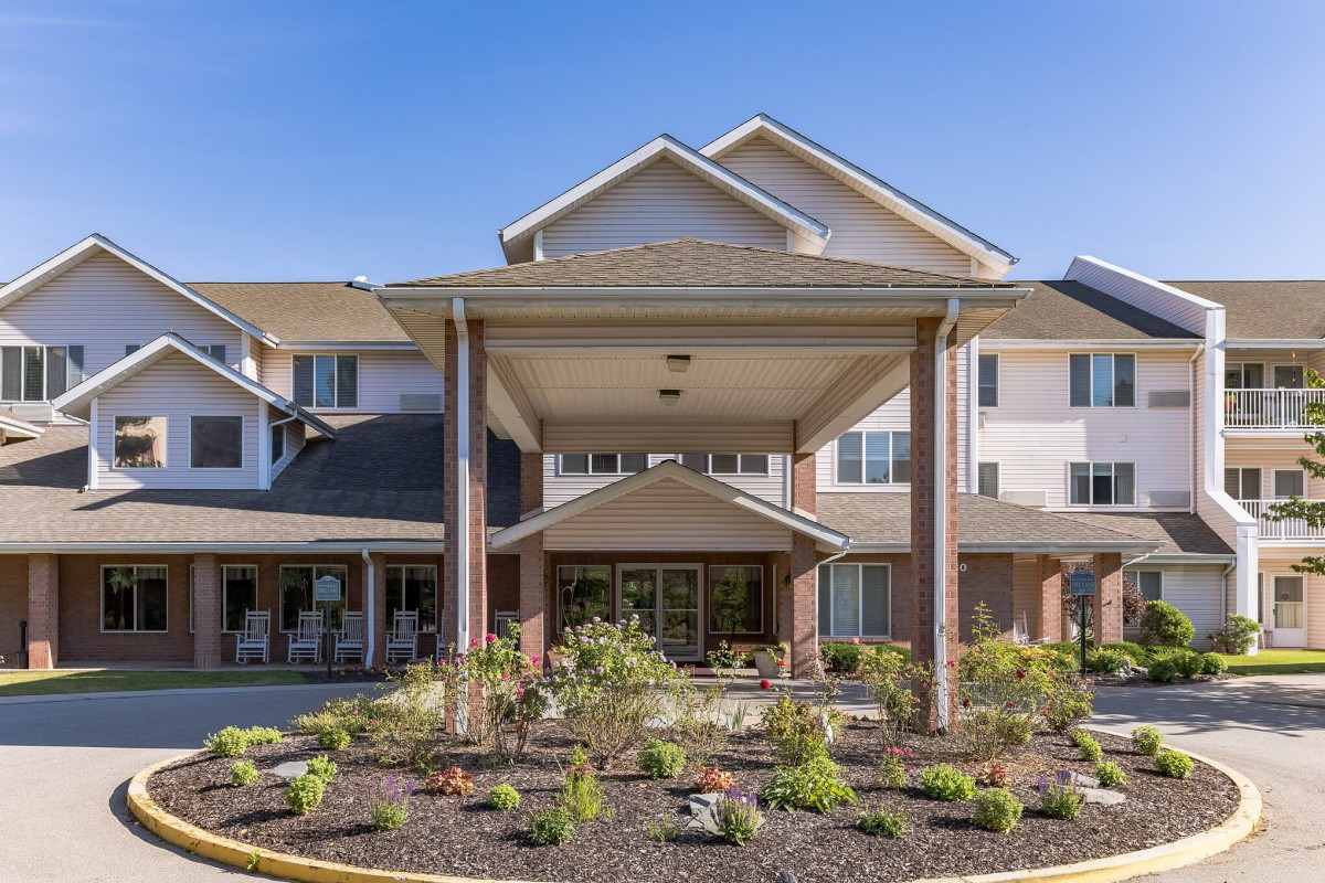 A modern residential building with a landscaped entrance.