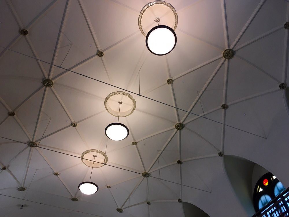 A geometric ceiling design with circular lights.