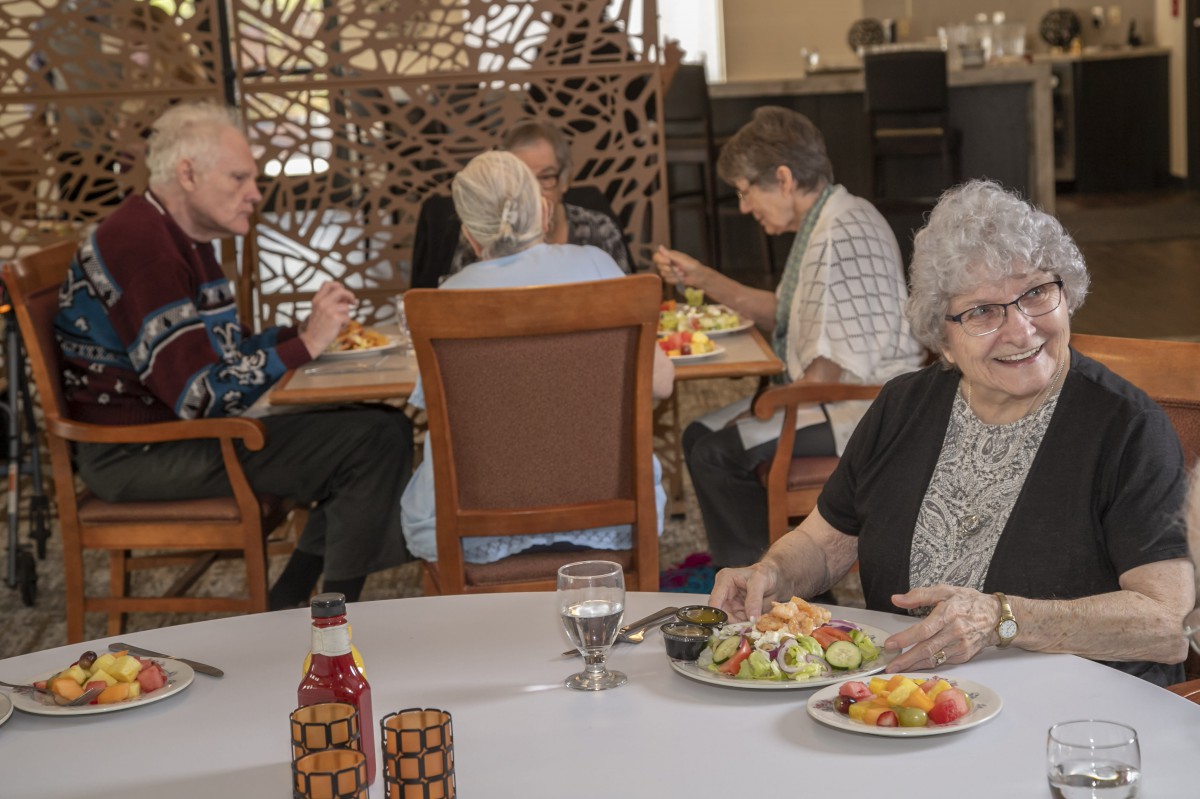 A group of elderly people enjoying a meal together in a restaurant setting.