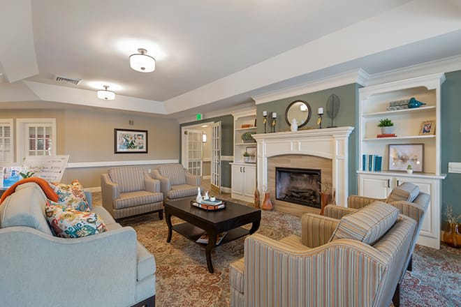A cozy living room featuring elegant furniture and a fireplace, creating a warm and inviting atmosphere.