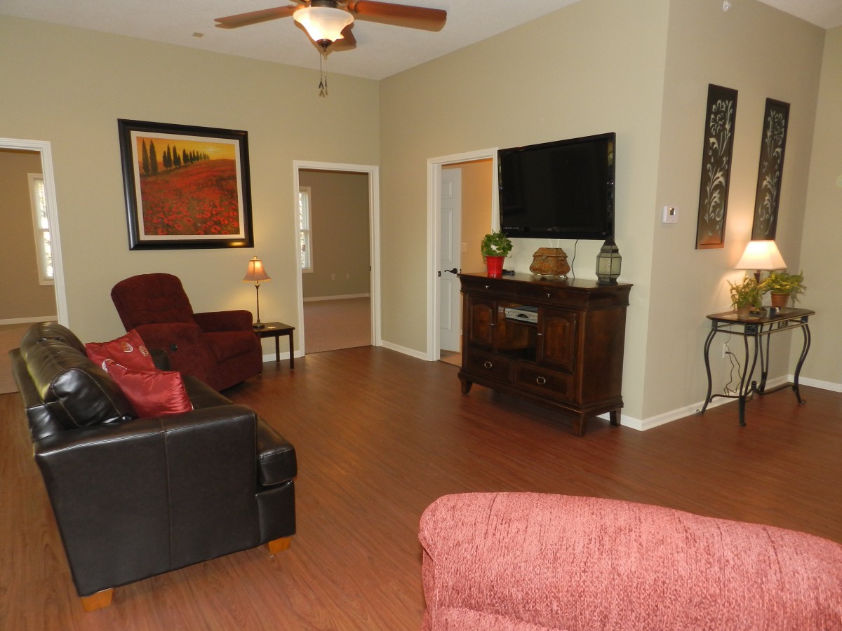 A cozy living room with comfortable seating, a television, and warm decor.