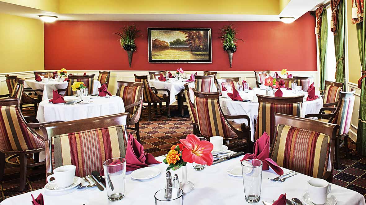 A well-decorated restaurant dining room with tables set for guests.