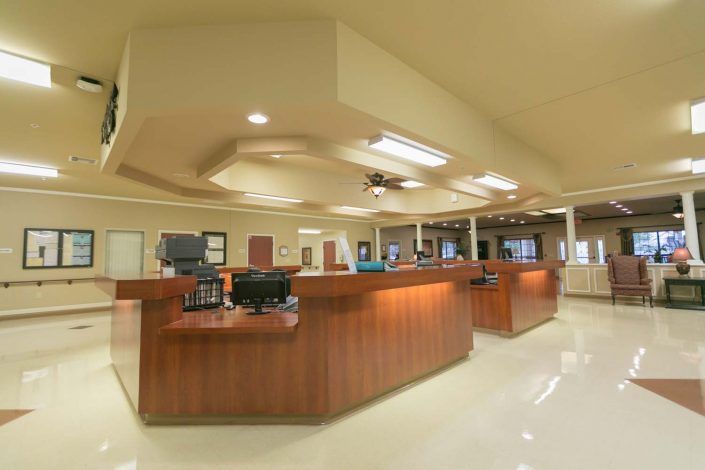 A hospital reception area with a central desk and bright lighting.