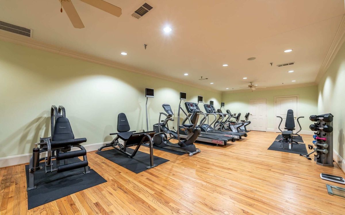 A well-equipped indoor gym with treadmills and other fitness machines.