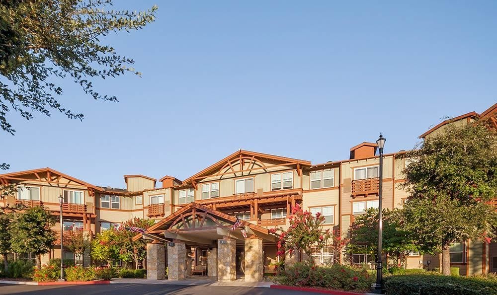 A welcoming hotel entrance with rustic architecture.
