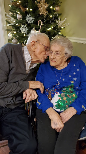 An elderly couple sharing a tender moment during the holiday season.