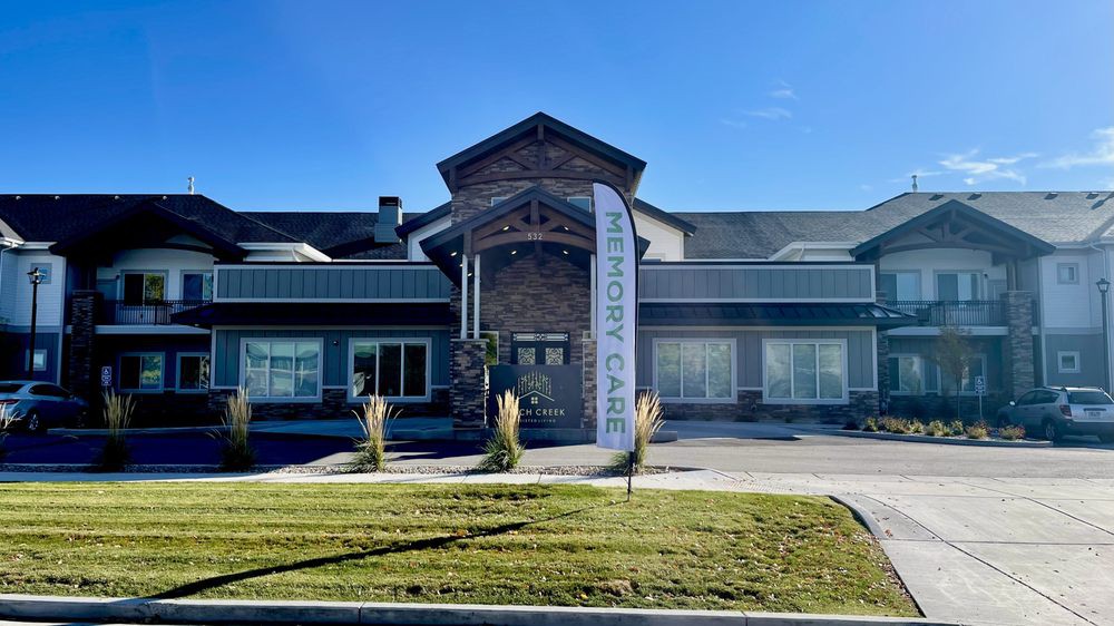 A modern commercial building with a well-maintained landscape on a sunny day.