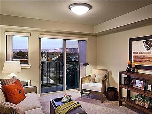 A cozy living room featuring a modern design with a balcony view.