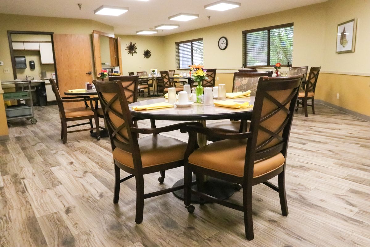 A cozy dining room with neatly arranged tables and chairs, ready for guests.