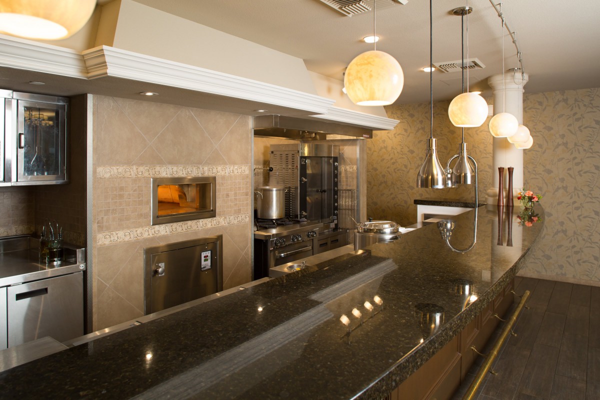 Modern restaurant kitchen interior with sleek design and ambient lighting.