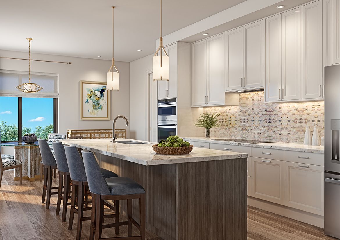 A modern kitchen featuring an island counter with bar stools and pendant lighting.
