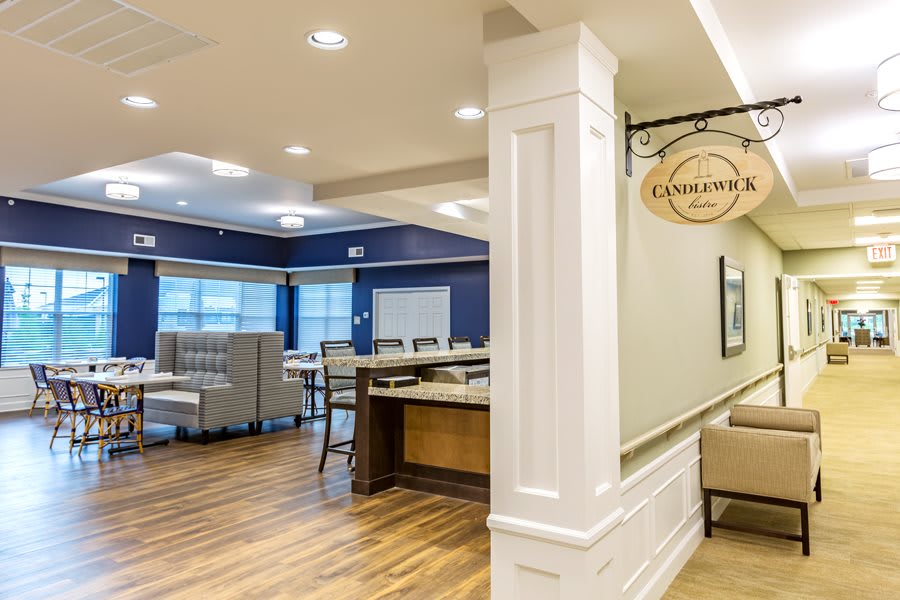 A modern dining area with elegant furnishings and warm lighting.