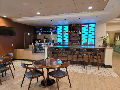 A modern cafe interior featuring a stylish bar counter and comfortable seating.