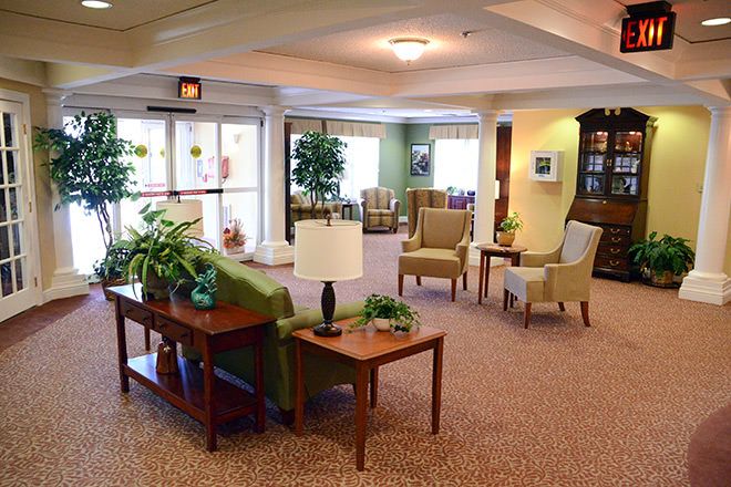A well-lit lobby area with comfortable seating and decorative plants.