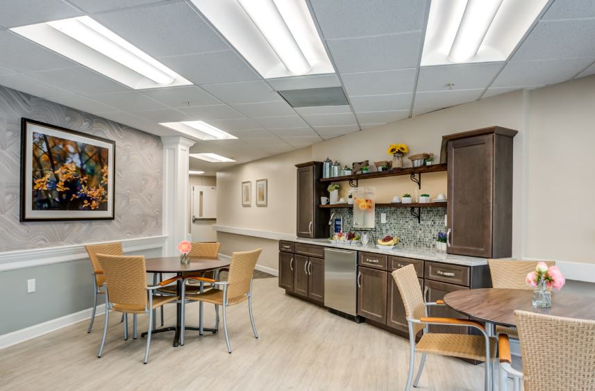 A modern break room with kitchen facilities and seating area.