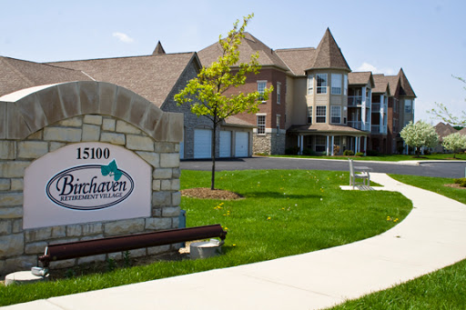 A sunny day showcasing an apartment complex with well-maintained landscaping.