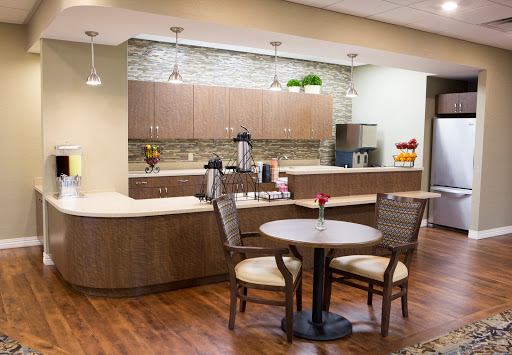 A cozy and modern kitchen area featuring a small dining table and coffee station.