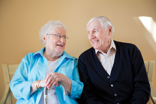 A joyful elderly couple sharing a moment of laughter.