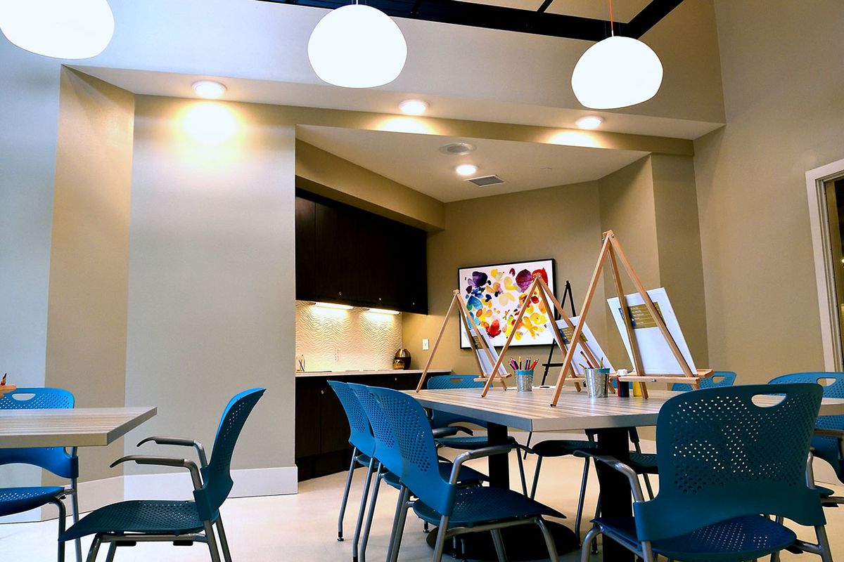 A modern art studio with easels and bright lighting.
