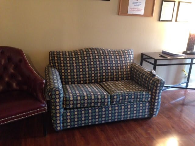 A plaid-patterned sofa in a living room setting.