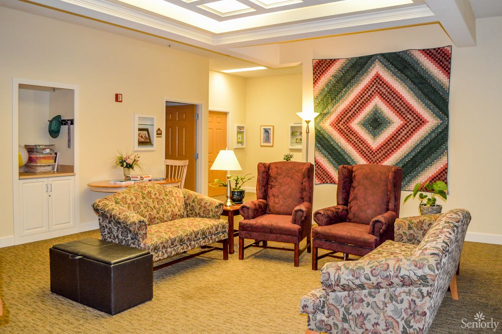 A cozy lobby area with comfortable seating and colorful artwork on the wall.