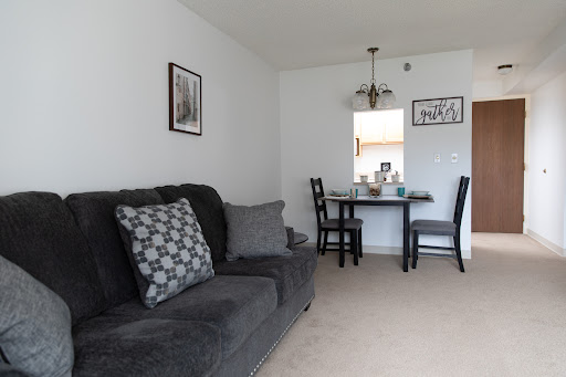 A cozy living space featuring a comfortable sofa and a dining area with elegant decor.