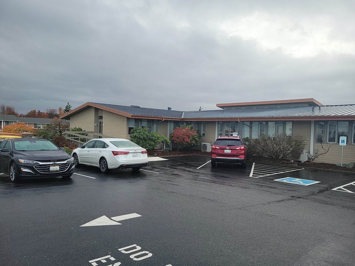 A parking lot beside a building on an overcast day.