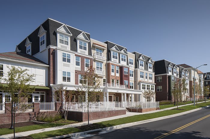 A modern residential apartment complex in a suburban neighborhood.
