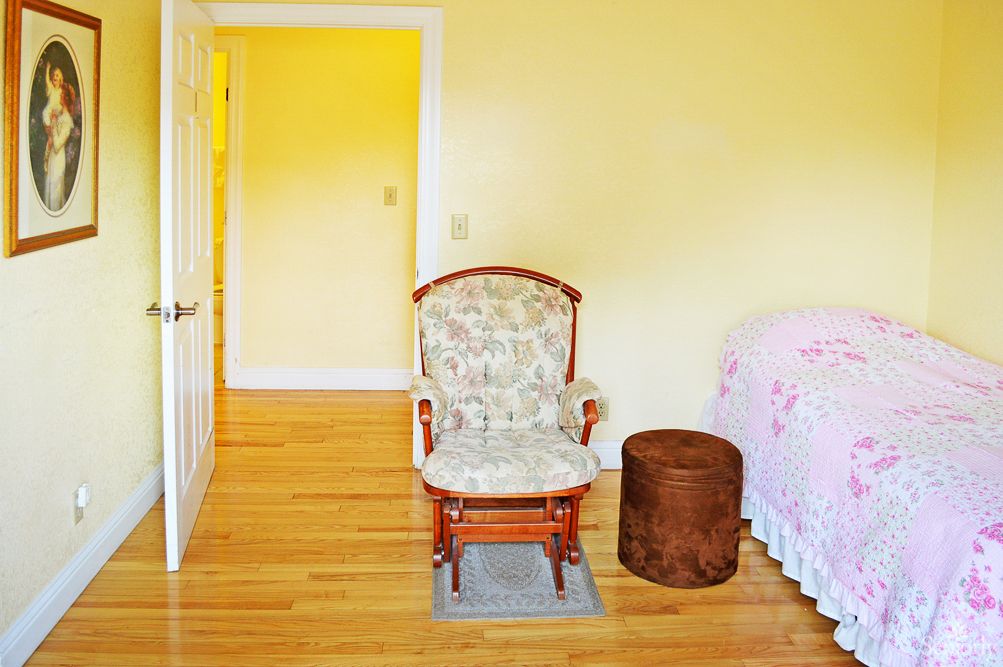 A cozy bedroom featuring a rocking chair and elegant interior design.