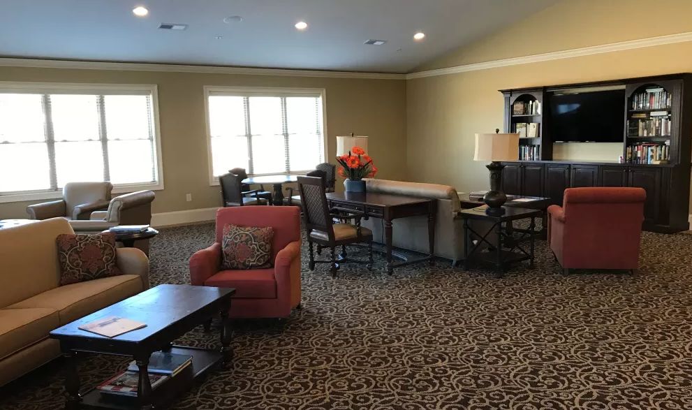 A cozy living room with comfortable furniture and ample natural light.