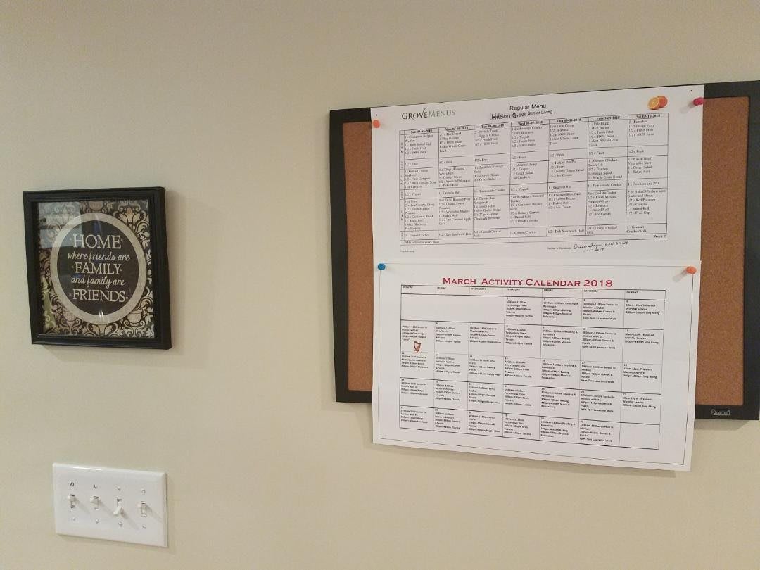 A schedule is pinned to a notice board on the wall, next to a decorative plaque.