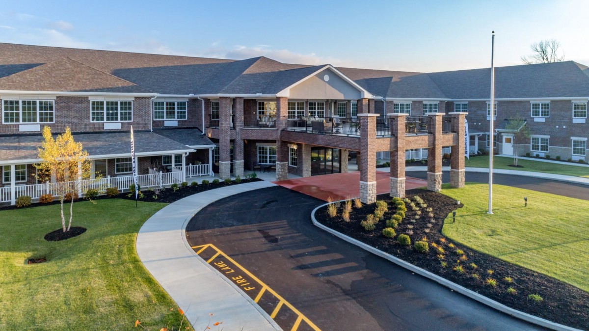 A modern residential building with a welcoming entrance and landscaped surroundings.