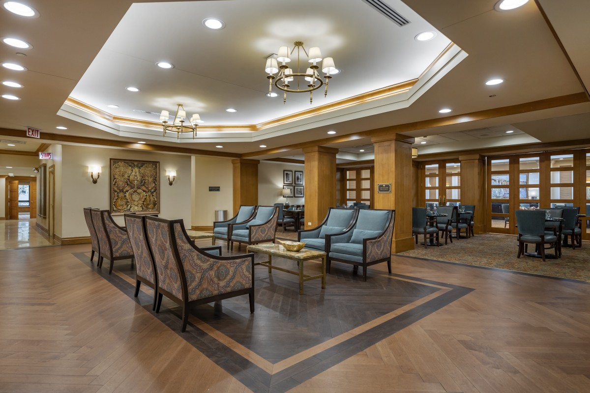 A modern lobby area with elegant seating and chandeliers.