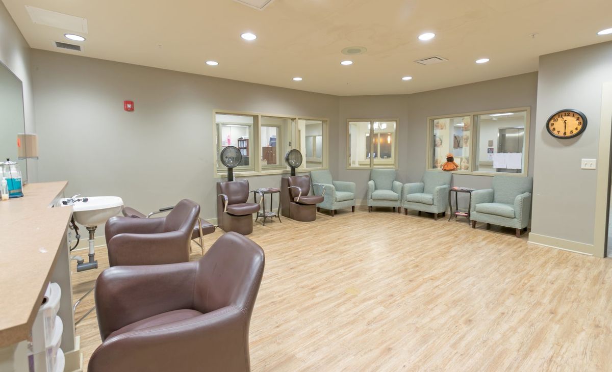 A spacious waiting area with modern chairs arranged in a circle.