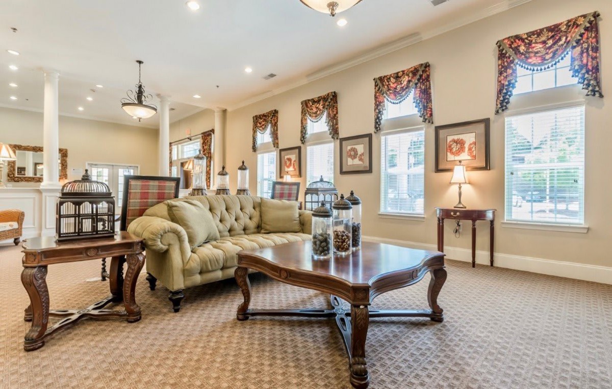 A well-decorated living room with traditional furniture and elegant lighting.