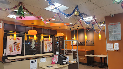 A vibrant fast food restaurant interior decorated with colorful streamers.