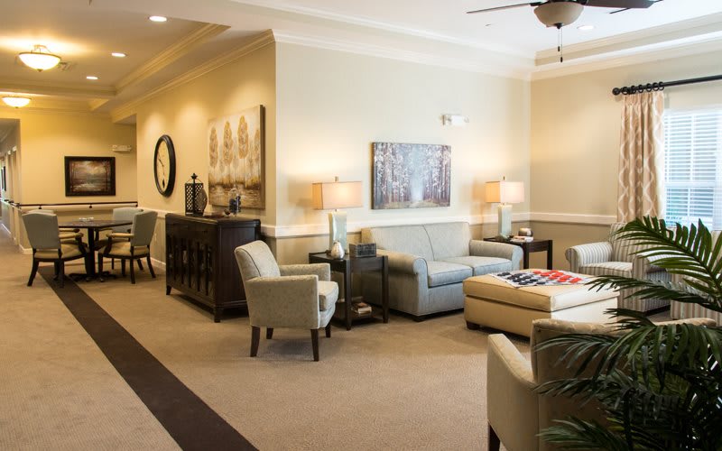 A modern and cozy living room with comfortable seating, elegant lighting, and stylish decor.